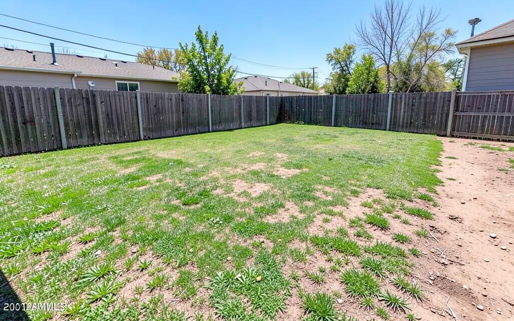 Empty patchy suburban backyard before ADU construction